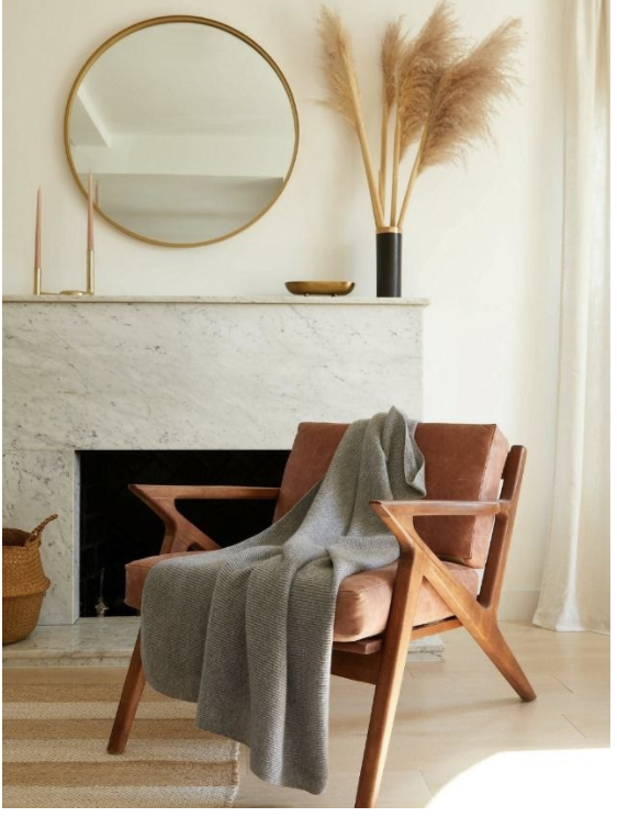 home interior featuring neutral-toned furniture, a fireplace, mirror, and décor