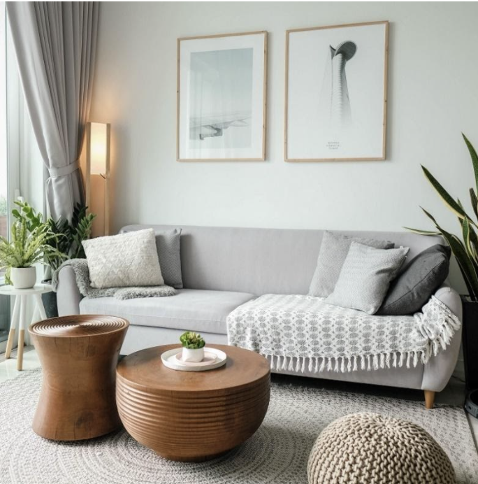 A living room with art on the wall, a white couch, and a coffee table