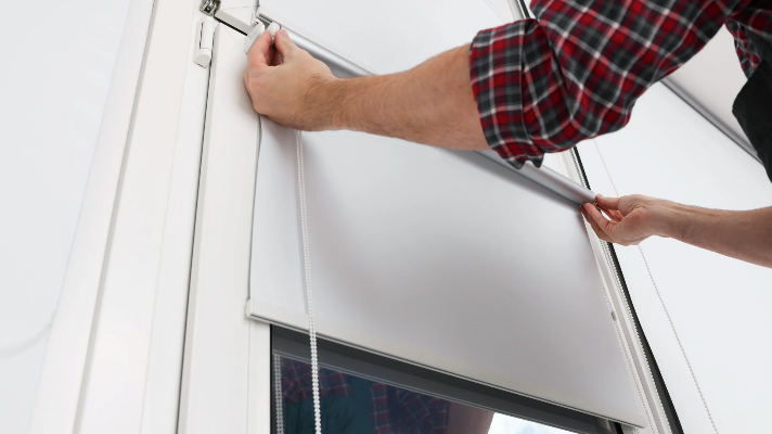 Soundproofing Blinds – Person Installing Roller Blinds