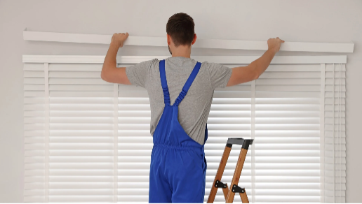 Person Installing Window Blind Outside Window Frame